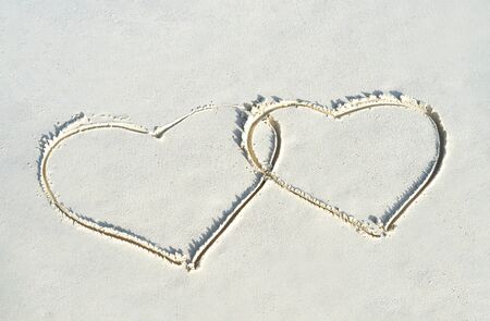 Heart shape on white yellow sand beach. Love concept for Valentine Day or summer vacation.の写真素材