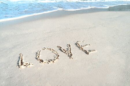 Love on the sea sand. Love concept for Valentine Day or summer vacation.の写真素材