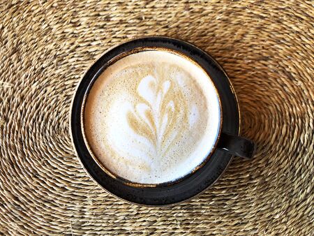 Cup of coffee on tropical background. Tropical travel concept. Close up.