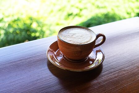 Cup of coffee on tropical background. Tropical travel concept. Close up.の写真素材