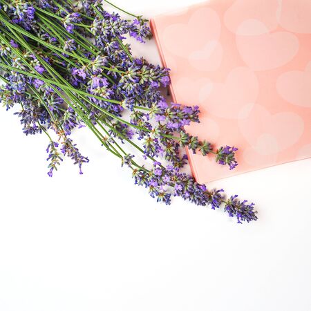 Lavender flowers and gift box with sweets on white background, isolated. Valentine's day, beauty, medical clinic, spa concept. Flat lay, copy space.の写真素材
