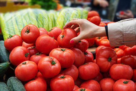 Woman buying fresh and organic fruits and vegetables at the green market or farmer agricultural market . Citizens buyers choose and buy products for healthy food.の写真素材