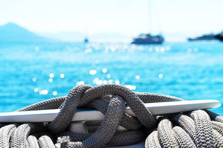 Yacht winch and cable on a sailing yacht. Rope wound on the small windlass of the yacht ship. Greece holiday.の写真素材