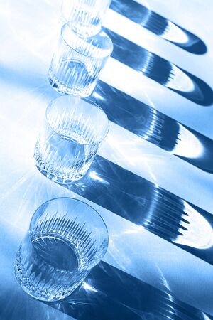 Trendy color pattern made with glasses and shadows on classic blue background. Classic Blue color of the Year 2020 inscription.の写真素材