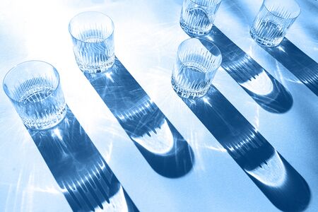 Trendy color pattern made with glasses and shadows on classic blue background. Classic Blue color of the Year 2020 inscription.の写真素材