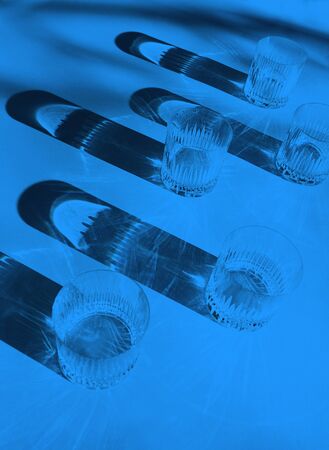 Trendy color pattern made with glasses and shadows on classic blue background. Classic Blue color of the Year 2020 inscription.の写真素材