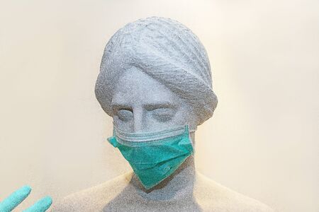 Head of sculpture of an antique woman in protective mask for anti-infection from respiratory sick.の写真素材