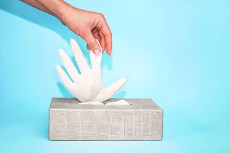 Concept of prevention from virus with rubber latex gloves on blueの写真素材