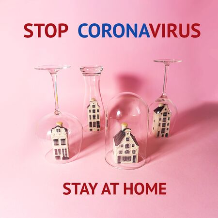 Concept of isolation or quarantine Stay at home. Pandemic idea with toy houses and glasses and copy space on pastel pink background. Outbreak of coronavirus concept. Novel virus - COVID-19, 2019-nCoV.の写真素材