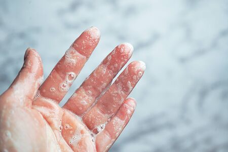 Washing hands woman on marble background, Coronavirus prevention hand hygiene. Corona Virus pandemic protection by cleaning hands. Outbreak of coronavirus concept. Novel virus - COVID-19, 2019-nCoV.の写真素材