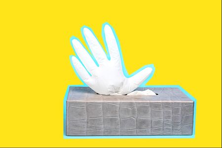 Art concept of prevention from coronavirus with rubber latex gloves on yellow background. Outbreak of coronavirus COVID-19 concept. Novel coronavirus - 2019-nCoV.の写真素材