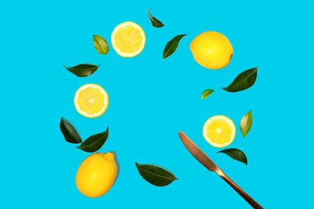 Creative layout made of flying yellow lemon with leaves on green mint color background. Trendy summer pattern. Minimal fashion concept. Flat lay, close up.の写真素材
