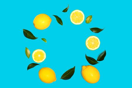Creative layout made of flying yellow lemon with leaves on green mint color background. Trendy summer pattern. Minimal fashion concept. Flat lay, close up.の写真素材