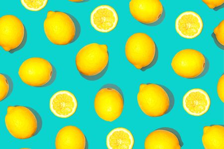 Pattern with lemon fruits. Tropical abstract geometric balance citrus on green mint color background. Trendy summer pattern. Minimal fashion concept. Flat lay, close up.の写真素材