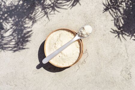 Closeup collagen with a spoon on concrete background. Trendy healthy and beauty concept.の写真素材