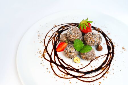 Energy balls or energy bites with oat, chocolate and coconut on pastel pinkの写真素材