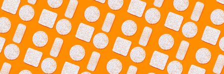 Pattern made of rice crackers or rice cakes on orange color background. Healthy organic food. Flat lay.の写真素材