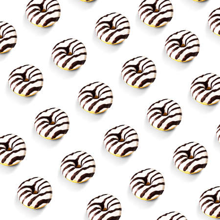 Glazed striped donuts on white background. Party food concept with copy space. Top view.の写真素材