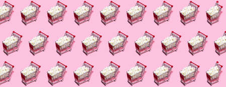 Shopping trolley pattern on pastel pink background. Shopping Cart as sign of Black Friday.の写真素材