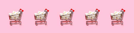 Shopping trolley pattern on pastel pink background. Shopping Cart as sign of Black Friday.の写真素材