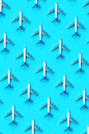 Pattern made of model airplane on blue background. Travel vacation summer concept. Top view, flat lay. Airlines out of service concept. Out of business airliners. Corona virus pandemic.の写真素材