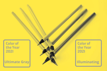 Abstract bright illuminating yellow and gray colours background with pencils. Trendy colors of the...