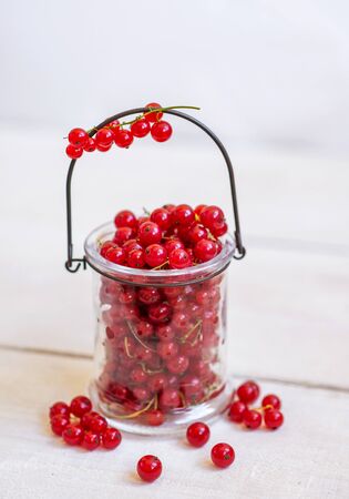 Fresh red currant on a light wooden backgroundの写真素材
