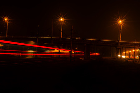 Lights on the railroad train of the night city.
