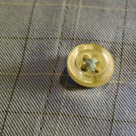 Sewn a button on a shirt