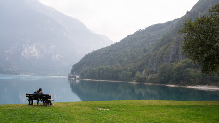 Lovers on a bench on the lakeの写真素材