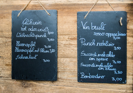 blackboards hanging on the wooden wall with a drink listの写真素材