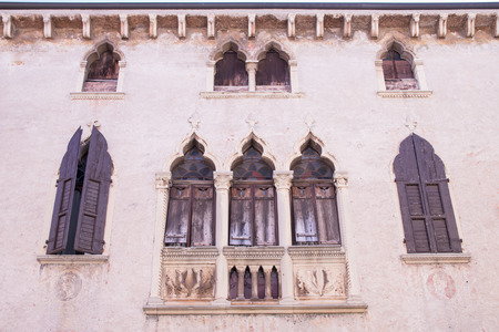 old windows on a medieval palace facade in Verona, Italyのeditorial素材