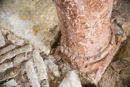 antique red marble columns resting on stone floorの写真素材