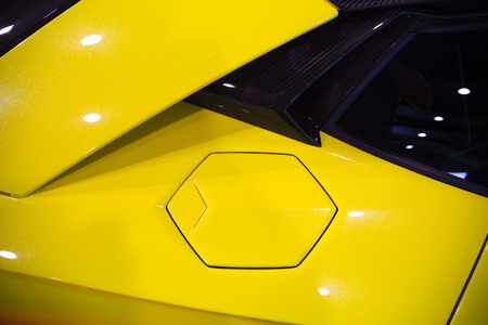 hexagonal fuel cap of a yellow sportscarの写真素材