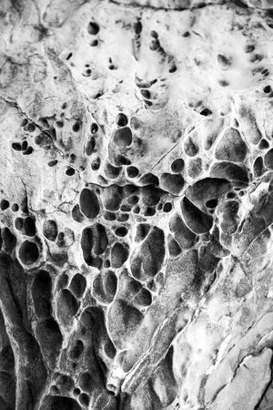 Background formed by a rock eroded by sea waves.の写真素材