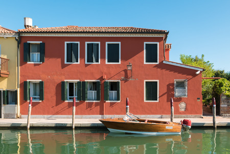 VENICE, ITALY CIRCA SEPTEMBER 2015: Typical Venetian house with boat used for transportation.のeditorial素材
