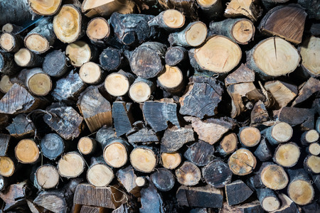 Background formed by a woodpile stored for winter.の写真素材