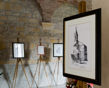 Villanova, Italy - September 7, 2014: Alessio Pegoraro, a contemporary painter from Verona, exhibits his works at the Romanesque abbey of Villanova.のeditorial素材