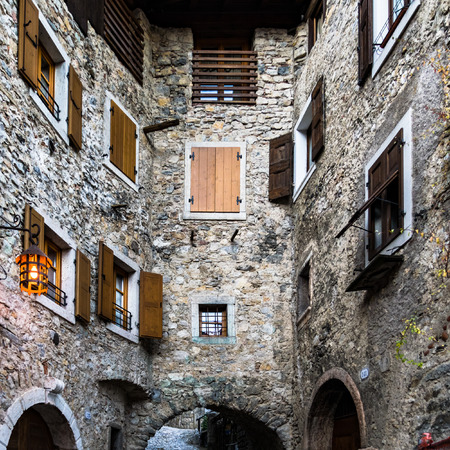 Many windows overlook in a narrow alley in a Medieval Italian village.の写真素材