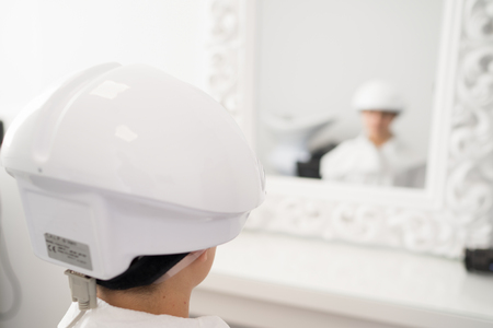 Scalp laser stimulation in a trichological clinic to promote hair regrowth.の写真素材