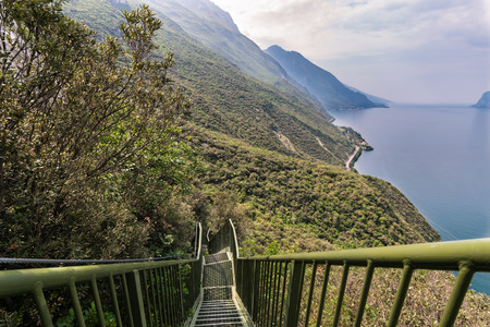 Panoramic iron staircase on Lake Garda along the trail from Busatte to Tempesta near the town of...