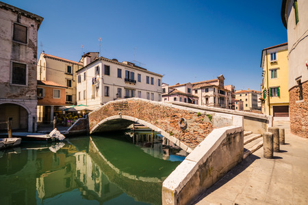 Typical bridge across a canal in Chioggia, Venetian Lagoon, Italy.の写真素材