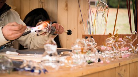 Craftsman decorating glass objects using a torch.の写真素材