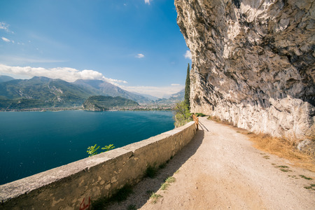 The Ponale trail carved into the rock of the mountain in Riva del Garda, Italy.の写真素材