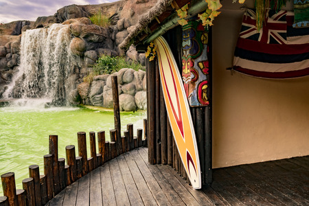 Honolulu, Hawaii - May 9, 2015: Photo shoot with Hawaiian hut and colorful surfboard.のeditorial素材