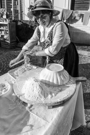 Verona, Italy - September 20, 2015: Italian woman preparing homemade pasta with white flour.のeditorial素材
