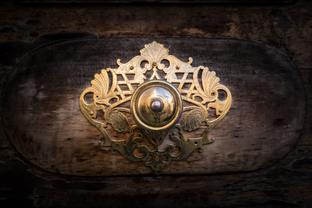 Golden metal decoration on the door of a Roman church used to protect the door and do not bump into the wall when it opens.の写真素材