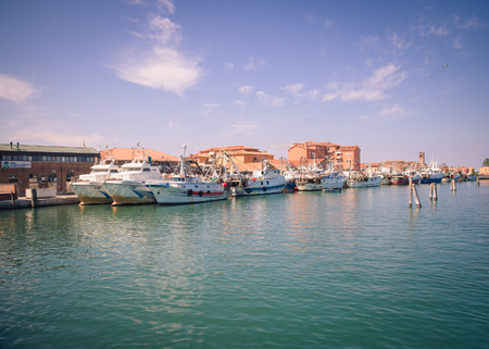 Chioggia, Italy - April 30, 2017: Fishing boats moored in a canal in Chioggia, Venetian Lagoon, Italy.のeditorial素材