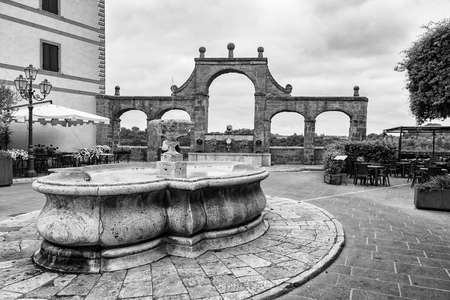 Ancient fountain on the historic center of Pitigliano village in Tuscany, Italy.の写真素材