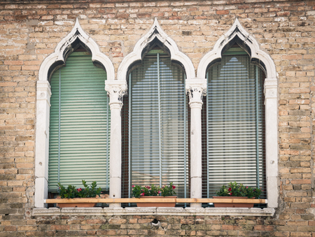 Old windows on a medieval palace facade in Verona, Italy.の写真素材